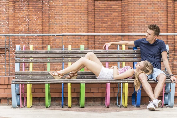 Young man with girlfriend lying on his knees — Stock Photo, Image