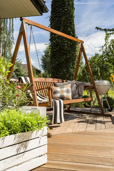 Villa patio with wooden garden swing — Stock Photo, Image