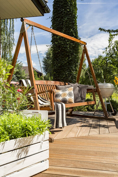 Villa patio with wooden garden swing