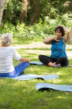 Bir parkta egzersiz gösterilen eğitmen