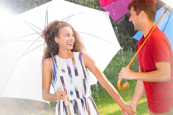 Man and woman with umbrella — Stock Photo, Image