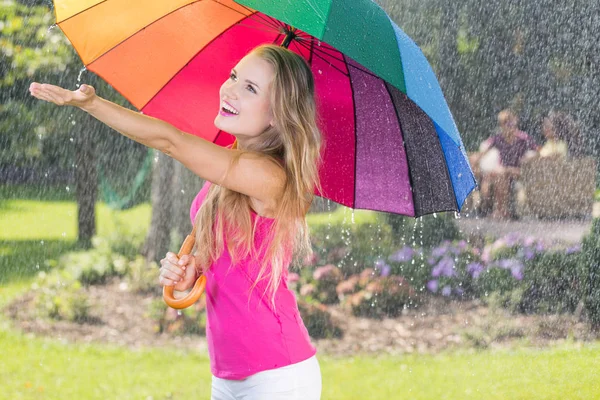 Woman touching raindrops — Stock Photo, Image