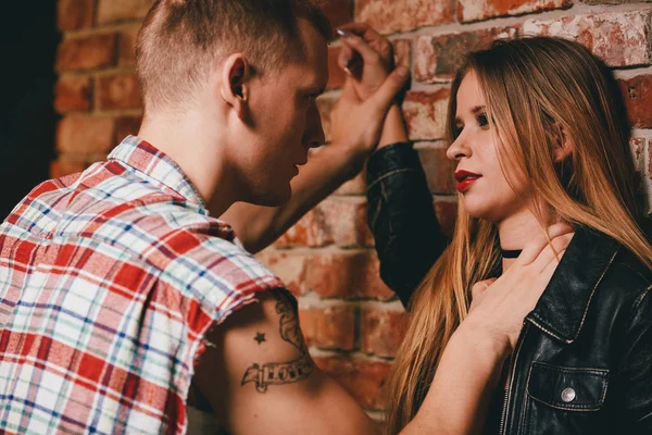 Pareja contra pared de ladrillo — Foto de Stock