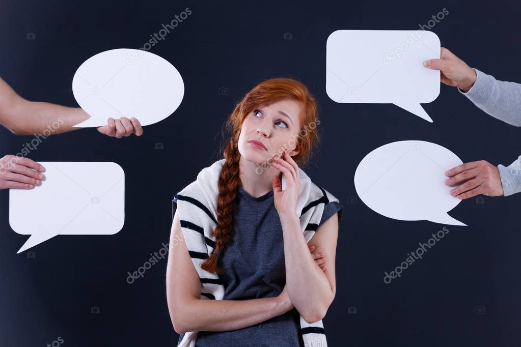 Woman surrounded by speech bubles