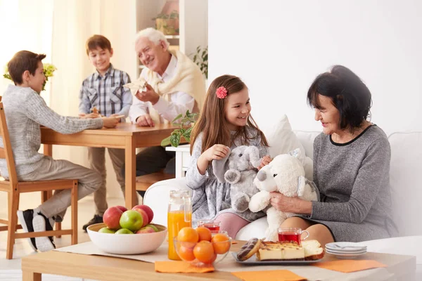 Sondotter visar hennes leksaker till mormor — Stockfoto