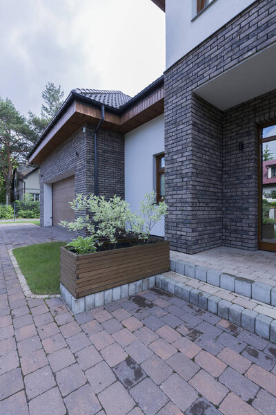 Modern front house entrance with paving stone doorway