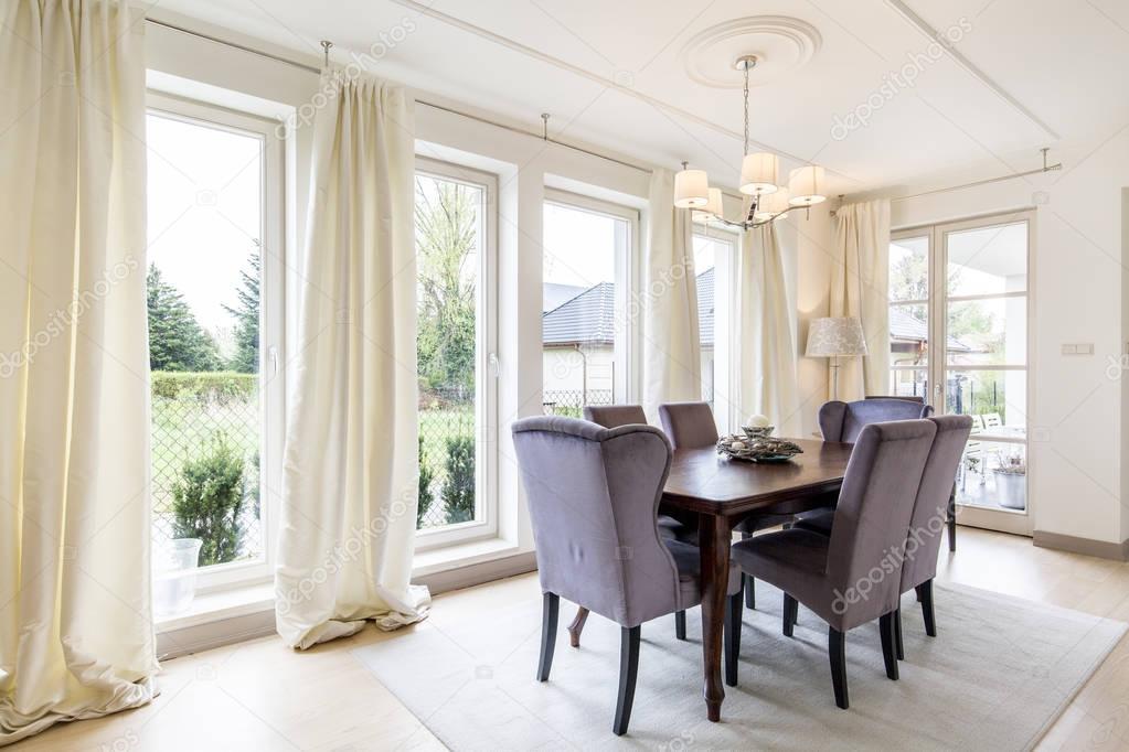 Spacious dining room in white tones