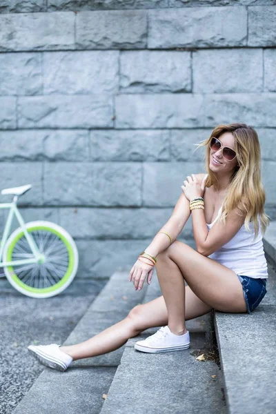 Mujer joven sentada en las escaleras — Foto de Stock