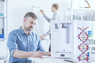 Man working using 3D printer clipart