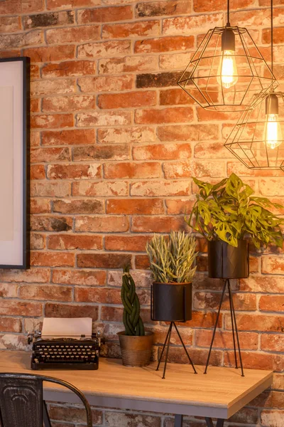 Home office with brick wall