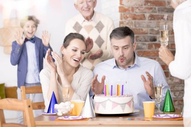 Man blowing out candles clipart