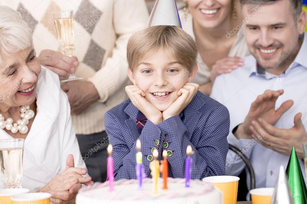 Birthday boy looking at cake