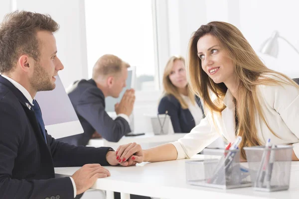 Businesswoman teasingly touching colleague during work — Stock Photo, Image