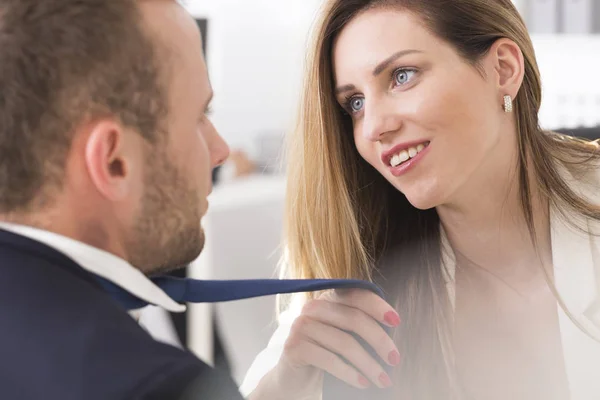 Attractive female boss grabbing co-workers tie — Stock Photo, Image