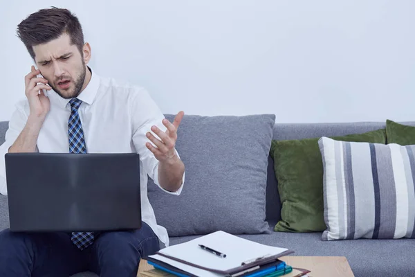 Zakenman die werken op een sofa — Stockfoto