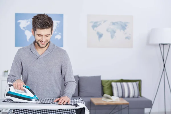 Man ironing in his room — Stock Photo, Image
