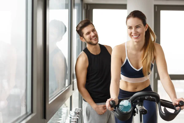 Handsome trainer and beautiful woman exercising - Stock Image - Everypixel