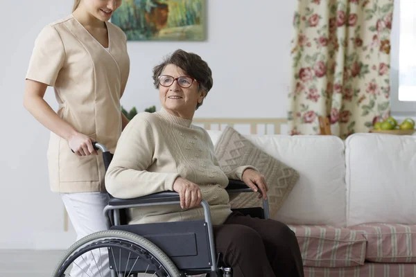 Woman on wheelchair and her nurse — Stock Photo, Image