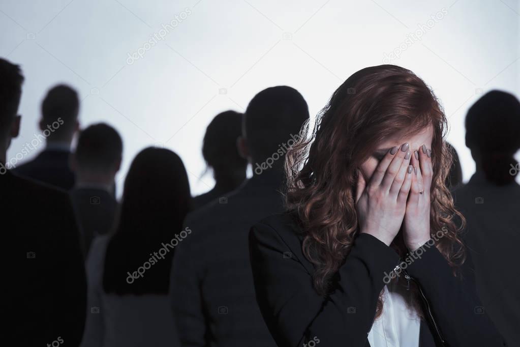 Woman crying in crowd