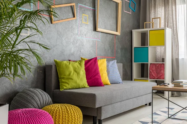 Grey room with colorful poufs — Stock Photo, Image