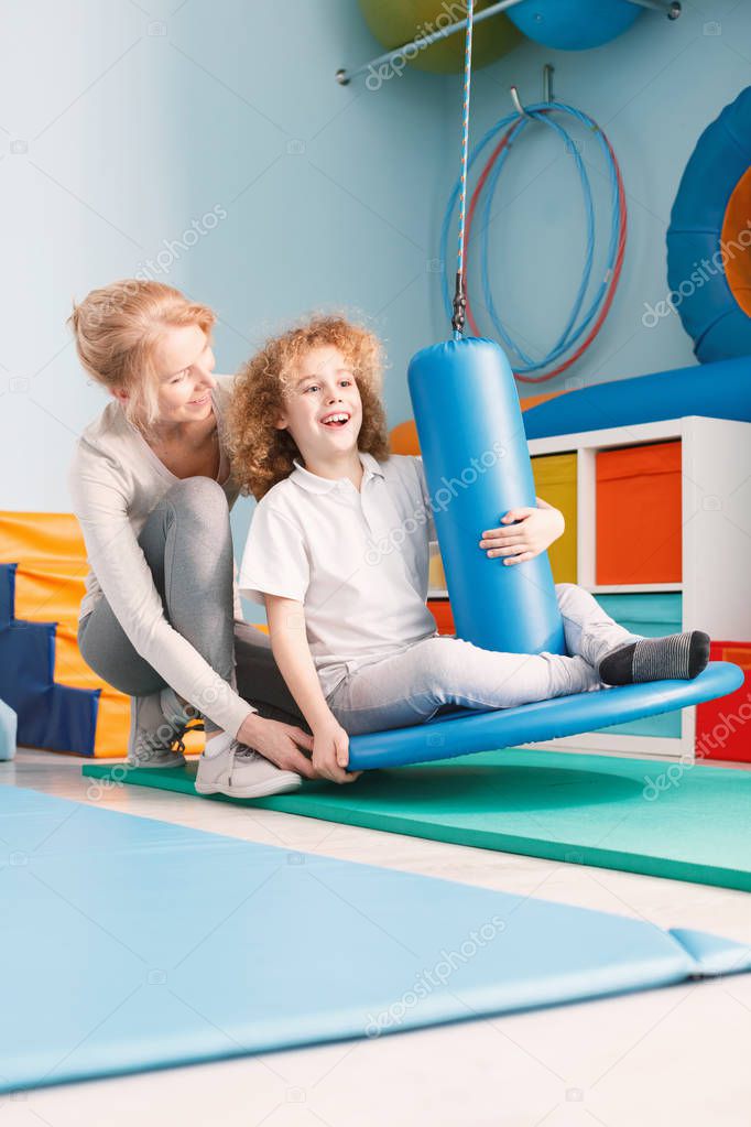 Child exercising with physiotherapist