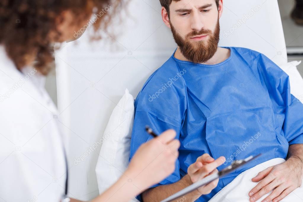 Psychiatric doctor diagnosing young man