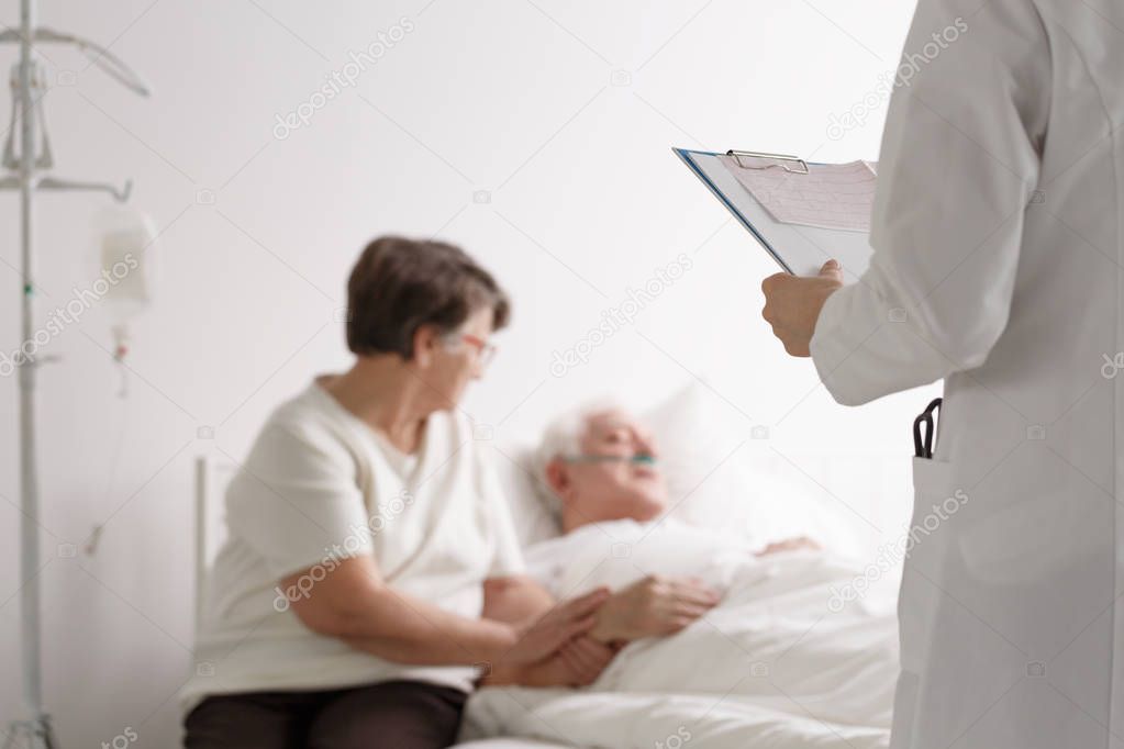 Supporting wife listening doctor's diagnosis