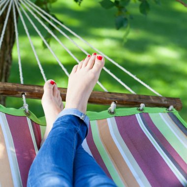 Hamakta dinlenen bir kadın