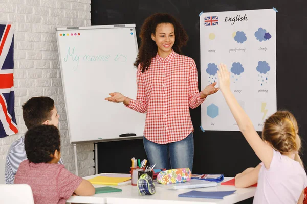 Junge Frau unterrichtet Kinder — Stockfoto