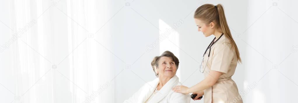 Woman on wheelchair and caregiver