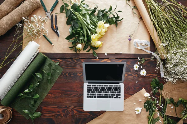Computer und Blumen auf dem Schreibtisch — Stockfoto