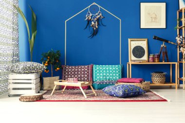 Oriental interior with colorful pillows clipart
