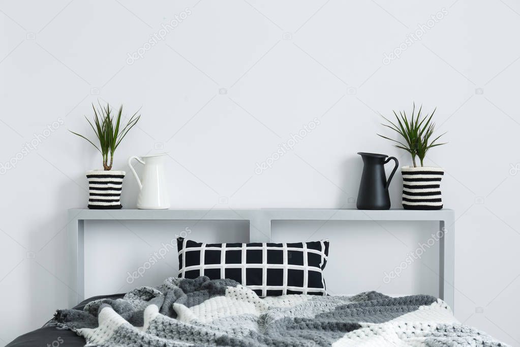 Bed, blanket, cushion, and plants