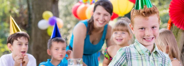 Pojke njuter fest med vänner — Stockfoto