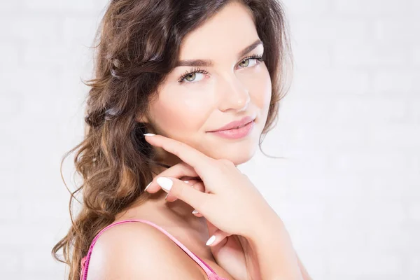 Brunette woman caressing her face — Stock Photo, Image