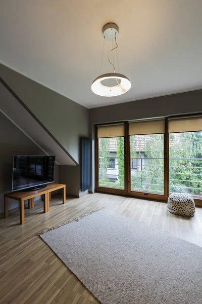 Cozy attic with TV set — Stock Photo, Image