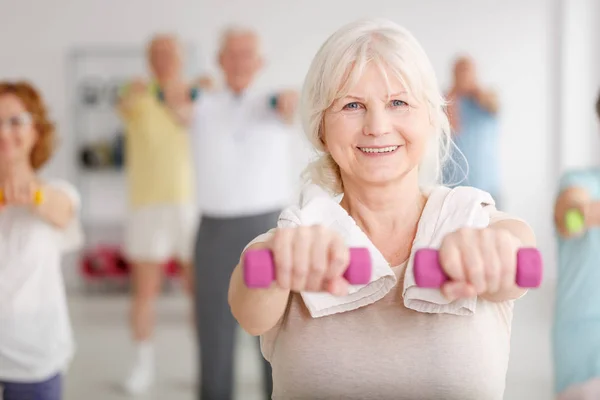 Exercising with dumbbells — Stock Photo, Image