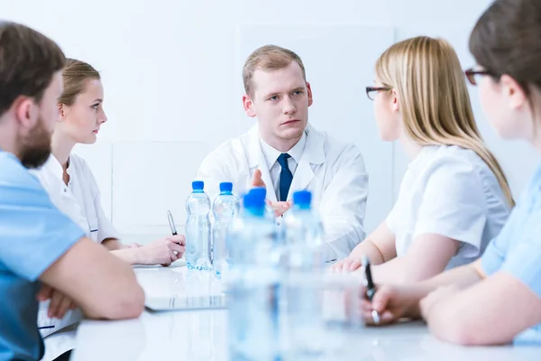 Conference with doctors in medical aprons — Stock Photo, Image