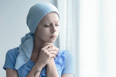 Woman with cancer praying clipart