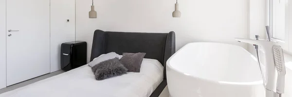 Bright bedroom with bathtub — Stock Photo, Image