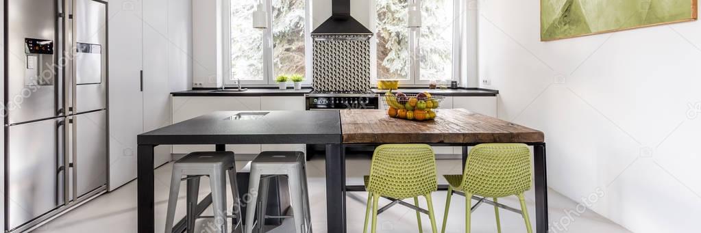 Bright functional kitchen with two tables