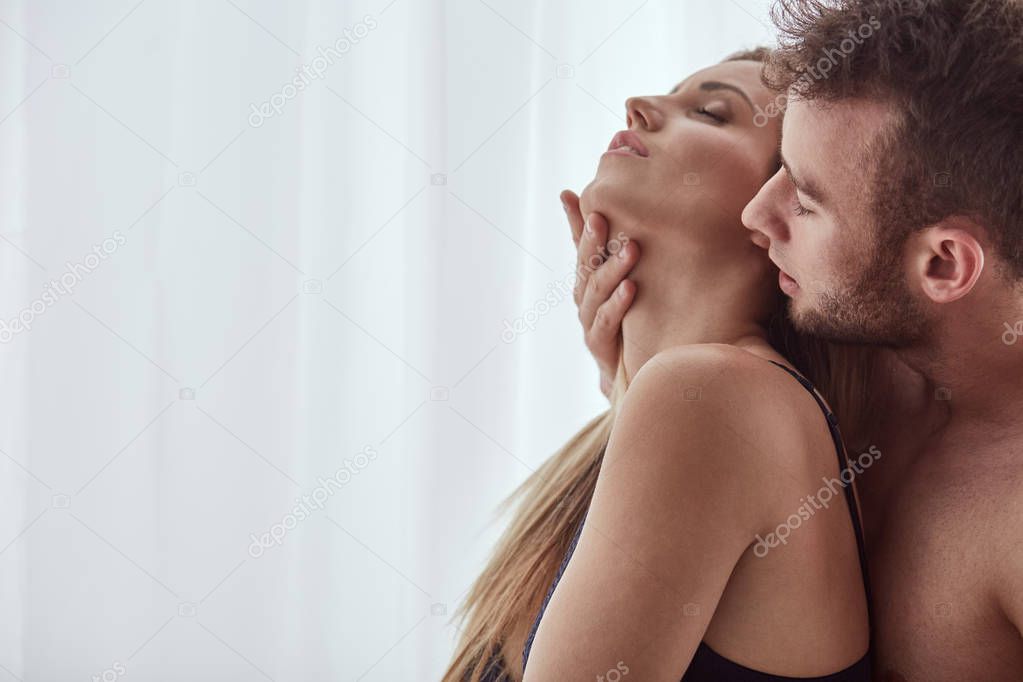 Man touching woman's neck