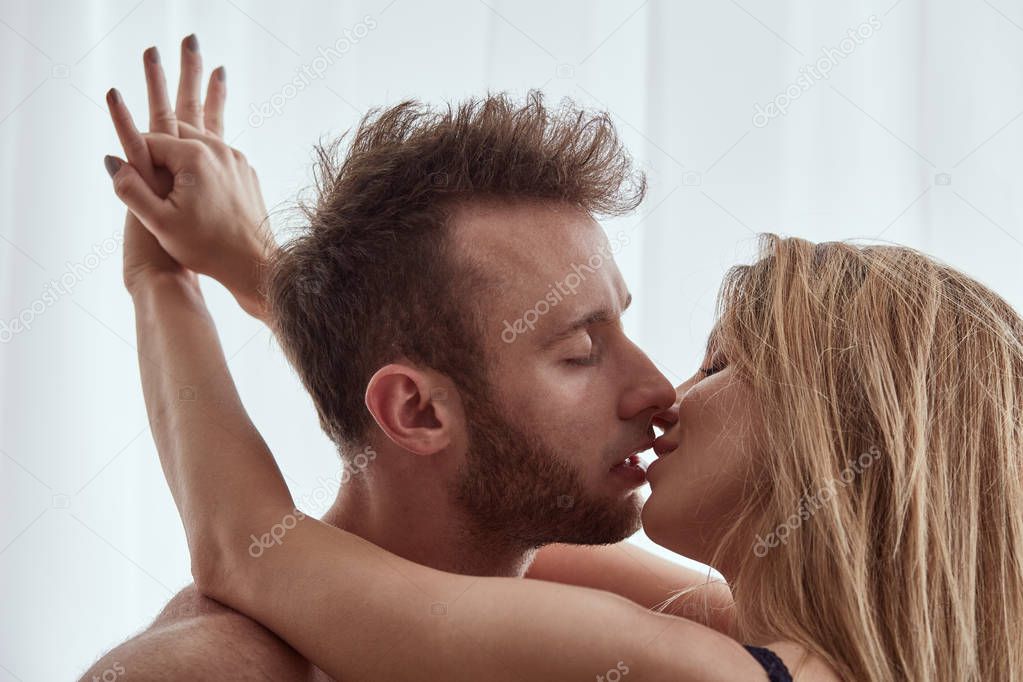 Woman embracing and kissing man