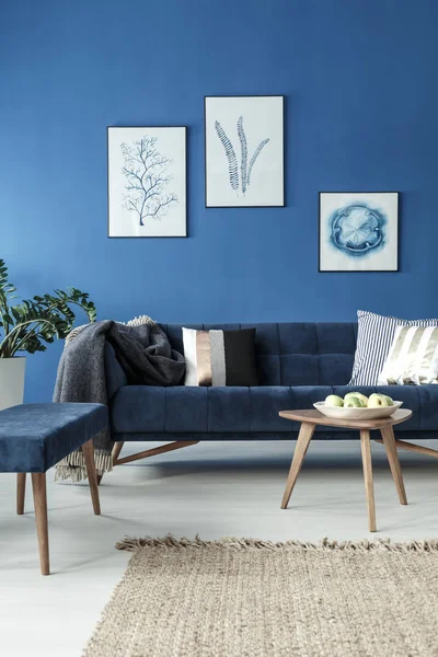 Sofa and end table in blue room