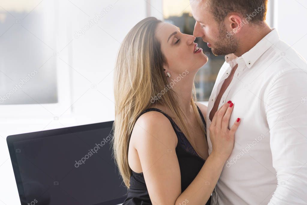 Sensual kiss at work