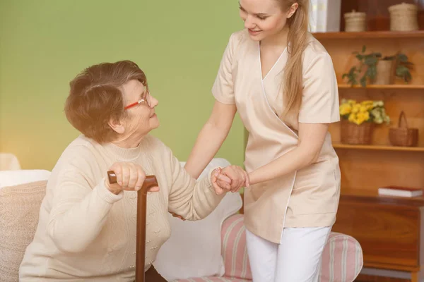 Zdravotní sestra pomáhá starší dáma — Stock fotografie