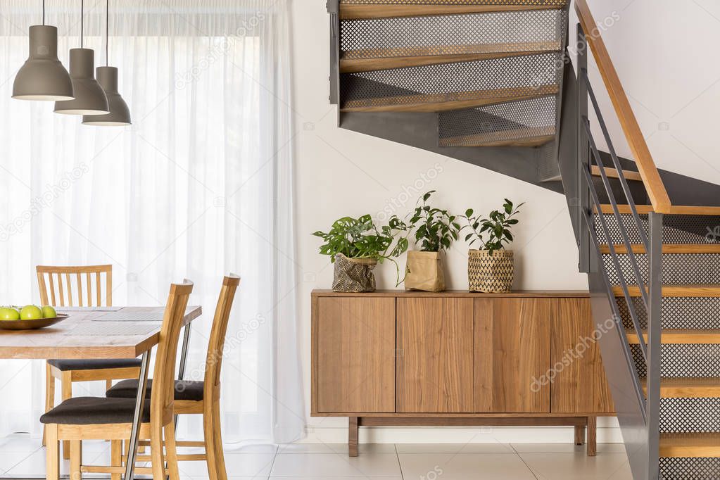 Dining room beside industrial staircase 