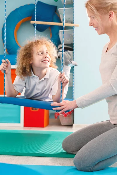 Boy using therapy swing — Stock Image Boy using therapy swing Stock Image