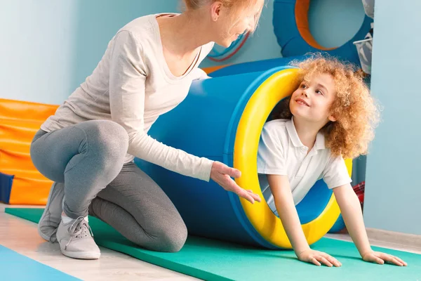Boy exercising with therapist — Stock Image Boy exercising with therapist Stock Photo