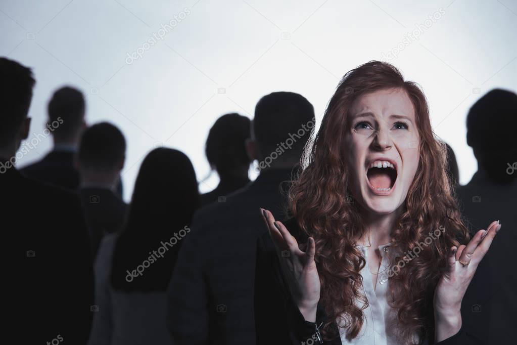 Screaming woman standing in crowd